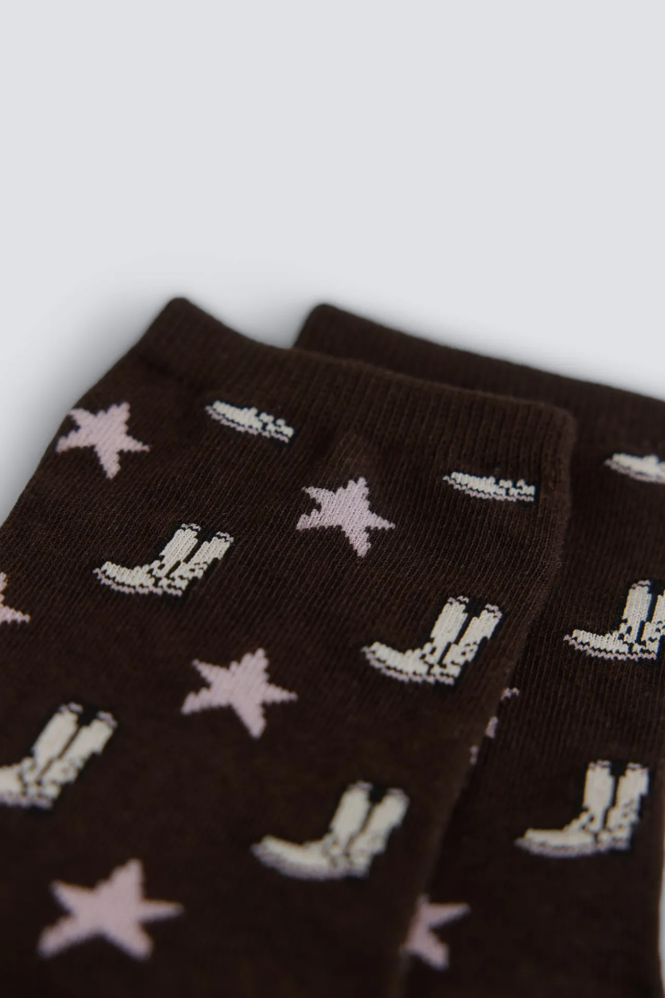 Chaussette longue à motifs bottes et étoiles